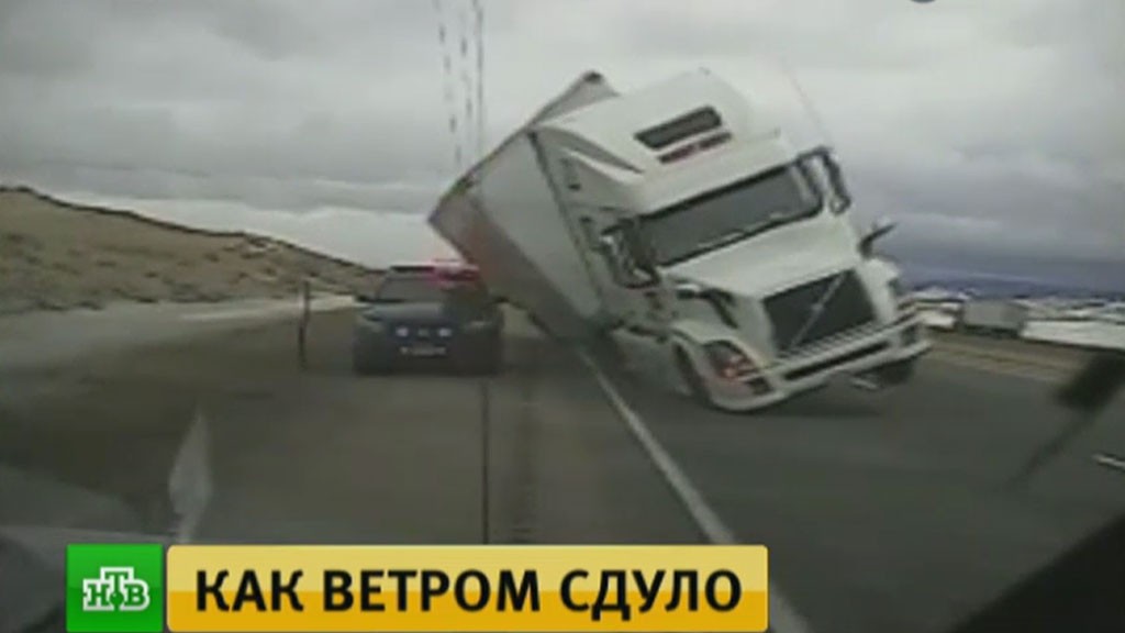 Падение снесенного ветром грузового автомобиля в США на полицейскую машину попало на видео